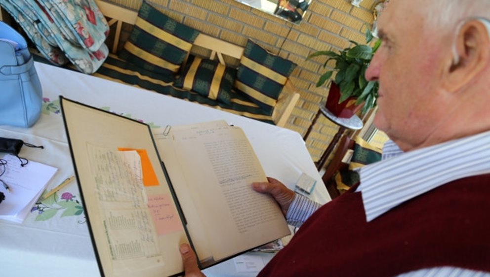 Man reads in a binder.