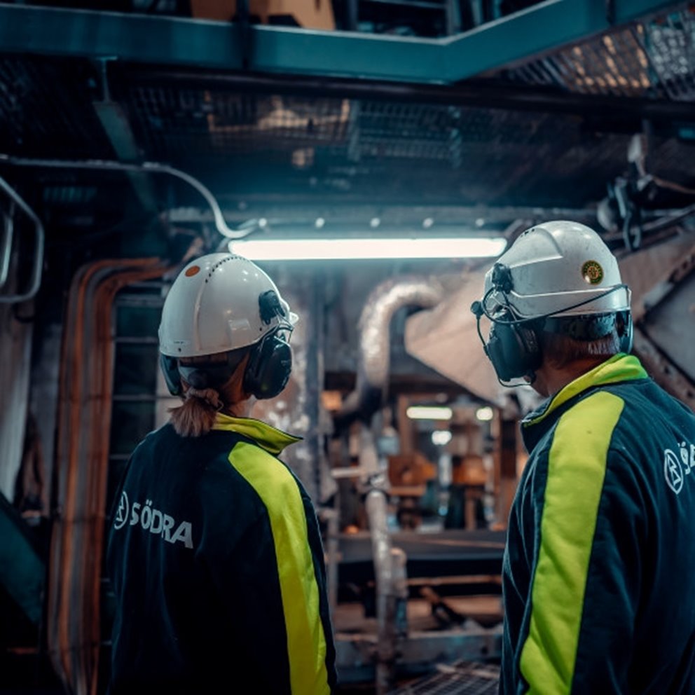 Två medarbetare i skyddsutrustning i Södras industri