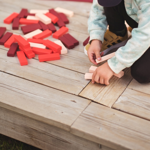 Child playing on wood deck